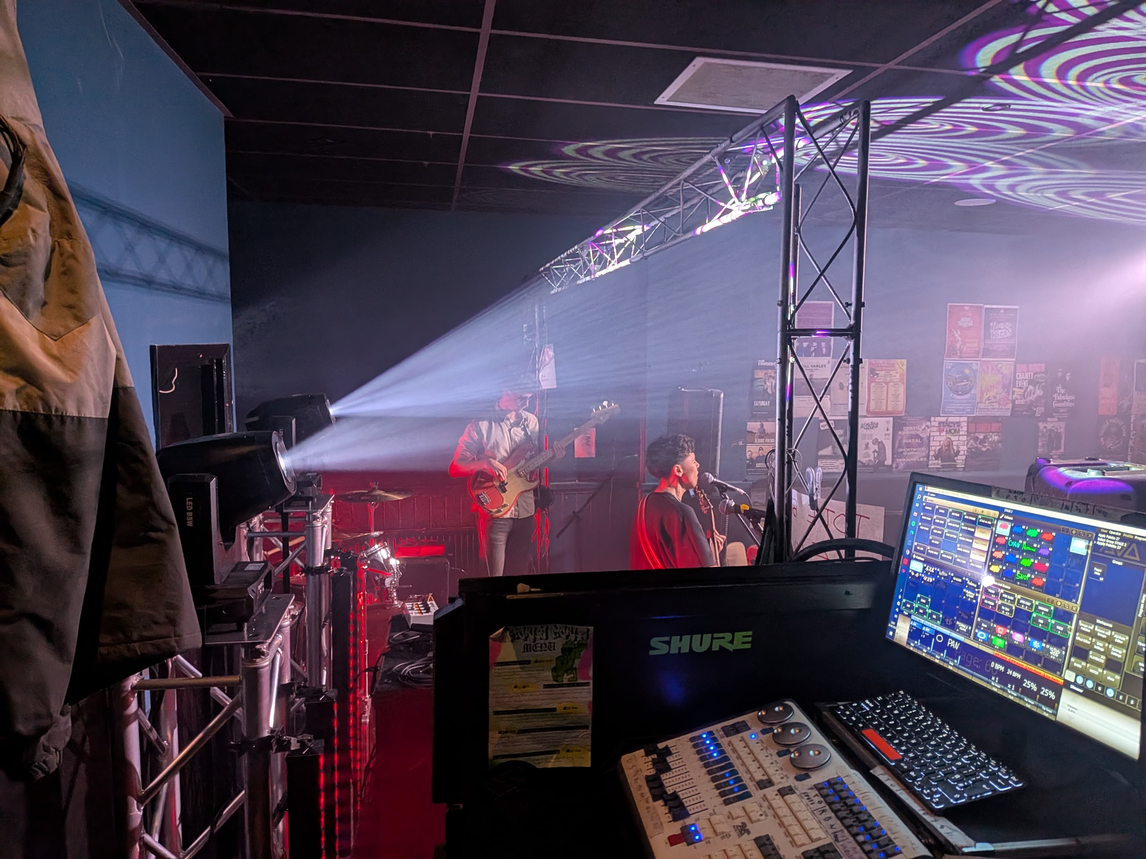 Digital mixing console beside a live stage