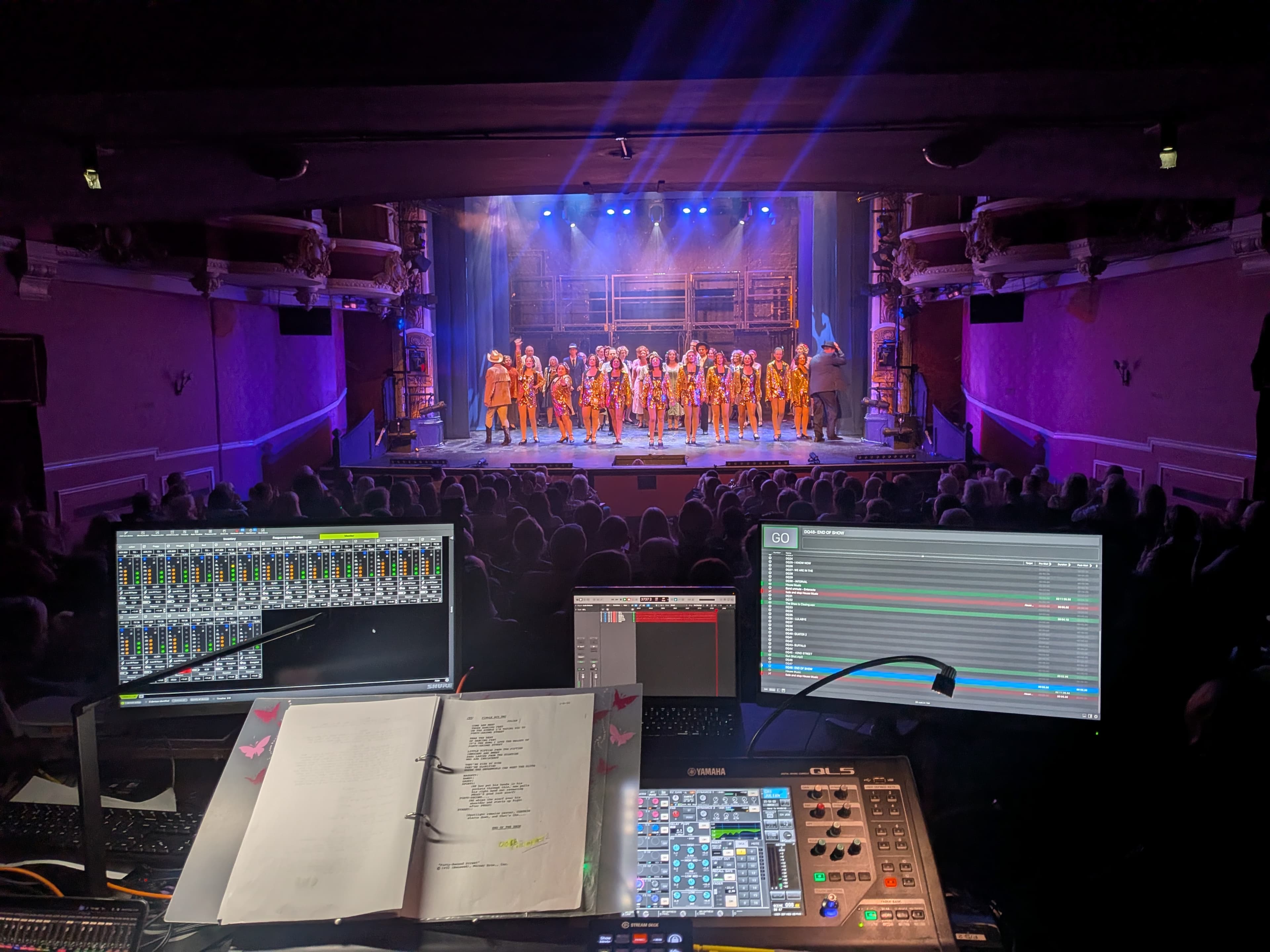 Theatre performance lit in blue and magenta